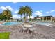 Inviting pool area featuring tables and chairs plus mature landscaping at 8848 Bismarck Palm Dr, Winter Garden, FL 34787