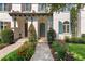 Charming home exterior with beautiful landscaping and inviting front entrance with arched door and paver walkway at 8848 Bismarck Palm Dr, Winter Garden, FL 34787