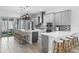 Bright, modern kitchen with quartz countertops, stainless steel appliances, large island with seating, and pendant lighting at 8848 Bismarck Palm Dr, Winter Garden, FL 34787