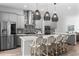 Modern kitchen featuring a center island with bar seating, stainless steel appliances, and stylish pendant lighting at 8848 Bismarck Palm Dr, Winter Garden, FL 34787