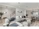 Spacious living room with plush sectional sofa, stylish decor, and modern open floor plan with view of staircase at 8848 Bismarck Palm Dr, Winter Garden, FL 34787