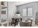 Well-lit office space featuring shiplap walls, a modern desk setup, and comfortable seating at 8848 Bismarck Palm Dr, Winter Garden, FL 34787