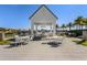 Covered outdoor seating area with tables and chairs by the lake at 8848 Bismarck Palm Dr, Winter Garden, FL 34787