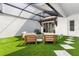 Outdoor patio featuring artificial grass, a fire pit, modern furniture, and a transparent roof at 8848 Bismarck Palm Dr, Winter Garden, FL 34787