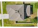 Aerial view of a home showing roof, driveway, lawn, and fenced yard at 889 Boxelder Ave, Minneola, FL 34715