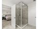 Nicely tiled shower in the bathroom adjacent to the main bedroom, features a glass enclosure at 889 Boxelder Ave, Minneola, FL 34715