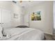 Bedroom with neutral decor, beach themed wall art and ample natural light at 889 Boxelder Ave, Minneola, FL 34715
