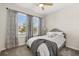Comfortable bedroom with a large window, curtains, and a bed with soft bedding at 889 Boxelder Ave, Minneola, FL 34715