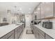 Well-equipped kitchen with stainless steel appliances, ample counter space, and a pantry at 889 Boxelder Ave, Minneola, FL 34715