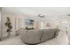 Comfortable living room with a large sofa, modern entertainment center, and neutral decor at 889 Boxelder Ave, Minneola, FL 34715