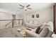 Upstairs Living Room area with plush carpeting, ceiling fan, with comfortable white reclining furniture at 889 Boxelder Ave, Minneola, FL 34715