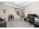 Open concept living space with tile floors and a view of the stairway at 889 Boxelder Ave, Minneola, FL 34715