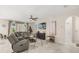 Cozy living room featuring an oversized sofa, entertainment center, and stylish decor at 889 Boxelder Ave, Minneola, FL 34715