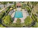 This luxurious pool area features a covered patio with outdoor seating and beautiful tropical landscaping at 889 Boxelder Ave, Minneola, FL 34715