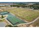Aerial view of community sports fields featuring baseball, tennis, and basketball courts near the neighborhood at 889 Boxelder Ave, Minneola, FL 34715