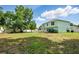Large backyard with landscaping and a two-story home with a privacy fence at 905 Cascade Falls Ln, Deland, FL 32720