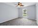 Bedroom with carpet, a ceiling fan, and a large window at 905 Cascade Falls Ln, Deland, FL 32720