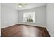 Bedroom with dark wood floors, a ceiling fan, and a large window at 905 Cascade Falls Ln, Deland, FL 32720