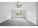 Spacious bedroom featuring a ceiling fan and view from the window at 905 Cascade Falls Ln, Deland, FL 32720