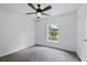 Carpeted bedroom features ceiling fan, window, and neutral tones at 905 Cascade Falls Ln, Deland, FL 32720