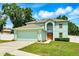 Inviting two-story home with a two-car garage, well-manicured lawn, and beautiful landscaping at 905 Cascade Falls Ln, Deland, FL 32720