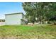 Exterior view of a home featuring new landscaping, privacy fence, and mature trees at 905 Cascade Falls Ln, Deland, FL 32720