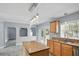 Kitchen with wood floors, granite countertops, center island, stainless steel appliances, and French doors at 905 Cascade Falls Ln, Deland, FL 32720