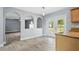Bright eat-in kitchen featuring wood floors, granite counters, and a view of the living room at 905 Cascade Falls Ln, Deland, FL 32720