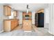 Bright kitchen featuring wood floors, granite counters, island, and stainless steel appliances at 905 Cascade Falls Ln, Deland, FL 32720
