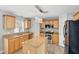 Bright kitchen features wood floors, stainless steel appliances, center island, and granite countertops at 905 Cascade Falls Ln, Deland, FL 32720