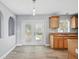 Bright eat-in kitchen featuring wood floors, granite counters, and a view of the backyard at 905 Cascade Falls Ln, Deland, FL 32720