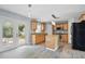 Bright kitchen featuring wood floors, granite counters, island, and stainless steel appliances at 905 Cascade Falls Ln, Deland, FL 32720
