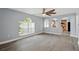 Living room features archways, wood floors, a ceiling fan, and a large window at 905 Cascade Falls Ln, Deland, FL 32720