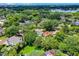 Wide aerial shot shows the property within a leafy, established neighborhood near a lake at 906 Alhambra Ct, Orlando, FL 32804