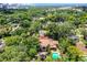 Aerial view showcasing the property's backyard, pool, and lush landscaping within a gated boundary at 906 Alhambra Ct, Orlando, FL 32804