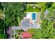 Stunning aerial view of the property, featuring a pool, backyard putting green, firepit, and lush landscaping at 906 Alhambra Ct, Orlando, FL 32804