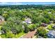 Scenic aerial showcases this property with a pool, blending into a lush, tree-filled community at 906 Alhambra Ct, Orlando, FL 32804