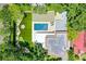Beautiful aerial view showcasing the home, pool, firepit, and putting green, all surrounded by mature trees at 906 Alhambra Ct, Orlando, FL 32804
