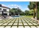 Resort-style backyard featuring a pool, lounge chairs, an outdoor kitchen and a basketball hoop at 906 Alhambra Ct, Orlando, FL 32804