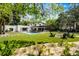 Spacious backyard with an inground pool, outdoor kitchen, fire pit area and mature trees at 906 Alhambra Ct, Orlando, FL 32804