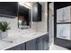 Bathroom with black cabinets, updated fixtures, and a glass shower at 906 Alhambra Ct, Orlando, FL 32804