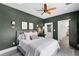 Charming bedroom with dark green walls and a door leading to a bathroom at 906 Alhambra Ct, Orlando, FL 32804