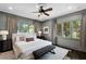 This primary bedroom offers a ceiling fan, natural light, neutral walls and a bench at 906 Alhambra Ct, Orlando, FL 32804