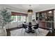 Dining area with a built-in bar and a modern light fixture above the table at 906 Alhambra Ct, Orlando, FL 32804