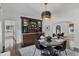 Well-appointed dining room featuring a built-in bar, modern light fixture, and seating for four at 906 Alhambra Ct, Orlando, FL 32804