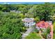 Lovely two-story home with a white exterior, red tile roof, and beautifully landscaped yard at 906 Alhambra Ct, Orlando, FL 32804