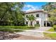Elegant two-story home showcasing a manicured lawn and charming brick paved driveway at 906 Alhambra Ct, Orlando, FL 32804