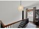 Hallway features wood railing, dark wood stairs, and natural light from window at 906 Alhambra Ct, Orlando, FL 32804