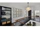Hallway featuring black staircase, gallery wall, and decorative shelving at 906 Alhambra Ct, Orlando, FL 32804