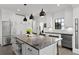 Bright kitchen with stainless steel appliances, large center island with seating, and modern fixtures at 906 Alhambra Ct, Orlando, FL 32804